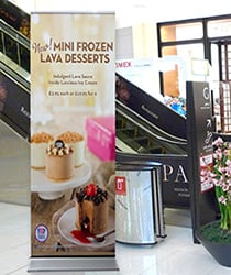 Promotional roller banner displayed in a shopping centre